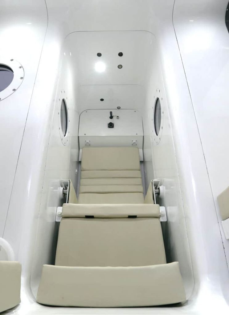 Interior of the Rockledge Hyperbaric multiplace oxygen chamber with comfortable ergonomic recliner seating and porthole windows